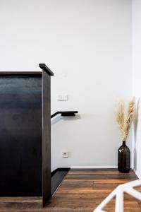 a black and white staircase in a room with a vase at Modern Downtown 1 BR Apartment in Reykjavík