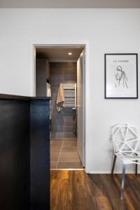 a walk in closet with a black door and a chair at Modern Downtown 1 BR Apartment in Reykjavík