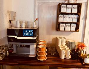 a coffee machine sitting on a table with cups at Gasthof Bräustübl in Selb