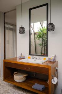 a bathroom with a sink and a mirror at The Bed by The Sea in Canggu