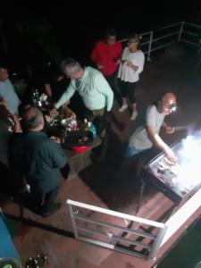 a group of people standing around a table at Hotel plutitor Sofia-Maria in Uzlina