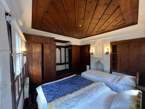 a bedroom with two beds and a wooden ceiling at SARI KONAK Garden Otel Safranbolu in Safranbolu +53 photos