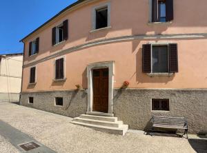 a building with a door and a bench in front of it at Casa Belvedere in Citerna