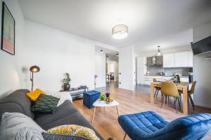 a living room with a couch and a table at Outdooredo Garda Apartment in Riva del Garda