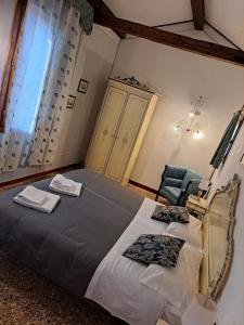 a bedroom with a large bed and a window at Locanda Ca' Formosa in Venice