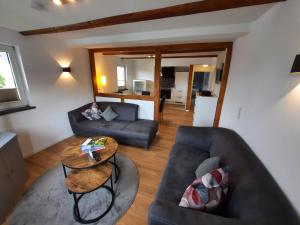 a living room with a couch and a table at Landhaus Gnacke in Schmallenberg