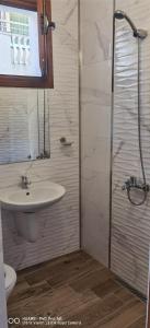 a bathroom with a sink and a shower at Джорджия in Kiten