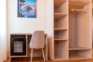 a room with a chair and a desk and a fireplace at Hotel Autoespresso Venice - Atika & Atif in Marghera