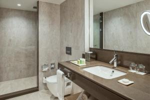 イスタンブールにあるルネッサンス ポラット イスタンブール ホテルのバスルーム(洗面台、トイレ、鏡付)