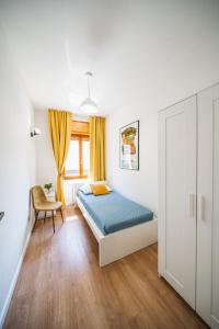 a bedroom with a bed and a chair at Outdooredo Garda Apartment in Riva del Garda