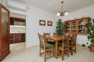a kitchen and dining room with a wooden table and chairs at Villa Ava in Kotor