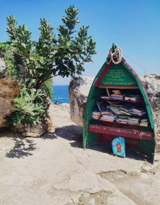 a book stand on the beach next to the ocean at Alba b&b in Polignano a Mare