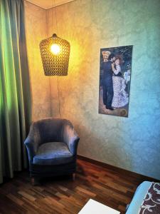 a room with a chair and a picture on the wall at ALBERGO BALDAZZI 1916 in Zavattarello