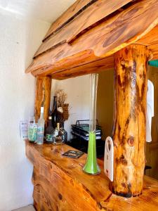 a wooden counter top with a green vase on it at Guest House Plitvice Waterfall in Plitvička Jezera