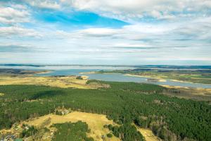 an aerial view of a river and a forest at Appartements "Zum Leuchtturm" Hafen Rankwitz Insel Usedom in Rankwitz