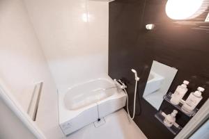 a small bathroom with a sink and a sink at Funhouse-to-101 North Umeda 12ppl Condo in Osaka