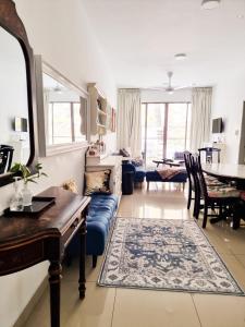 ein Wohnzimmer mit einem blauen Sofa und einem Tisch in der Unterkunft Mossy Forest Family Retreat, Kea Farm Brinchang in Brinchang