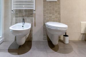 a bathroom with a toilet and a sink at Hotel Autoespresso Venice - Atika & Atif in Marghera