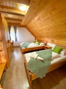 a bedroom with two beds in a wooden cabin at Guest House Plitvice Waterfall in Plitvička Jezera