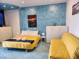a bedroom with two beds and a couch at Margiolà Amalfi in Amalfi