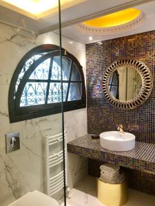 a bathroom with a sink and a mirror at Byblos Luxury Villa in Prinos