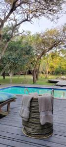 a towel sitting on a deck next to a swimming pool at Thornwood in KwaNibela