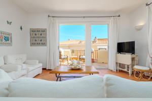 a living room with a couch and a table at Casa Olivastra in Porto Cervo