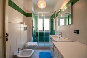 a bathroom with a sink and a toilet and a mirror at Casa Labertino in Rome