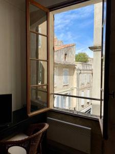 an open window with a view of a building at "Le central" Appart Arles in Arles