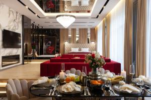 a dining room with a table with food on it at ARISTO Jacuzzi Hotel in Lviv