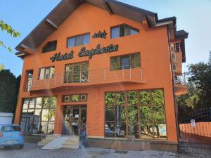 an orange building with a sign on it at Hotel Euphoria in Craiova