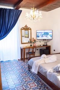 a bedroom with two beds and a desk and a mirror at Suite Nettuno Paestum in Paestum