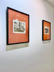 two framed photographs hanging on a white wall at Hotel Lidar in Bilbao