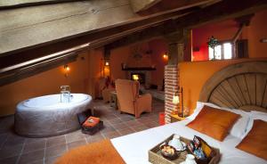 a bedroom with a large bed and a bath tub at El Planeta Escondido in Losana de Pirón