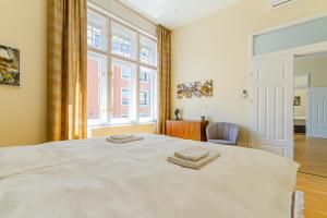 a bedroom with a bed with two towels on it at Bengt Apartment Kiraly Str. Luxury Suite in Budapest