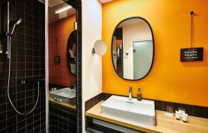 a bathroom with a sink and a mirror at Hotel Zugbrücke Grenzau GmbH in Höhr-Grenzhausen