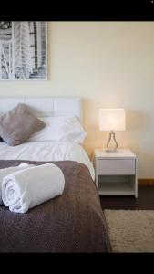 a hotel room with two beds and a lamp on a table at Luxury Holiday Home Albufeira in Albufeira