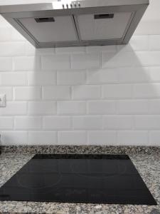 a kitchen with a sink and a counter top at Apartamento Aitue in Gijón +28 photos