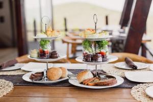 a table with three tiers of food on plates at Rhino Ridge Safari Lodge in KwaNompondo