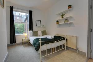 a small bedroom with a bed and a window at Home from Home 4-Bed Townhouse - Ideal for Families, Groups & Contractors, Free Parking, Pet Friendly, Netflix in Walkley