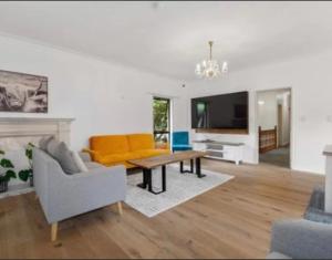 a living room with a couch and a table at Young Woods Lodge in Rotorua