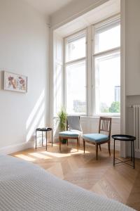 - une chambre avec deux chaises et deux fenêtres dans l'établissement Stunning Apartment in City Center, à Vienne