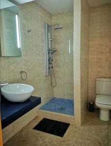 a bathroom with a shower and a sink and a toilet at Casa Hokie in Colonia de Sant Pere