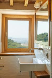a bathroom with a sink and two windows at Agriturismo Montecolombo by Il Ritorno in Sirolo