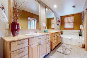a bathroom with a sink and a tub and a toilet at Evergreen Retreat, Unit 101 in Avon +58 photos