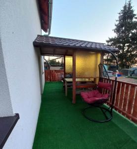 a deck with a gazebo and a table and chairs at Agroturystyka u Rolnika - Apartament in Stare Nowakowo