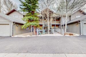 a large house with a garage and a driveway at Evergreen Retreat, Unit 101 in Avon