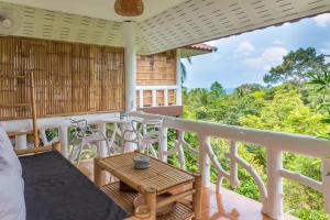 a room with a balcony with a table and chairs at Le Balcon, Haad Yao. in Haad Yao