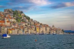 a view of a city from the water with boats at Apartman Megi in Šibenik