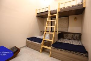 two bunk beds in a room with a ladder at Royal Retreat - 7BHK Luxury Villa with Turf in Lonavala +53 photos